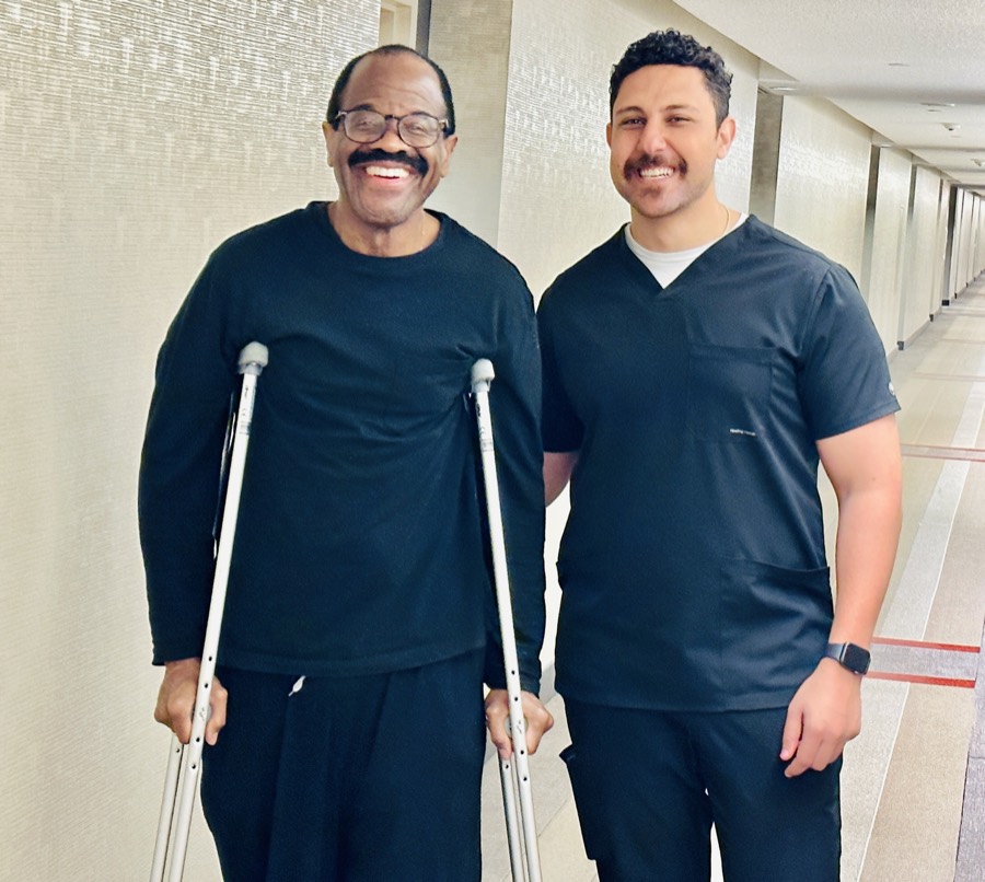 Dr. Michail Baskaron, Doctor of Physical Therapy, providing in-home physical therapy to a patient with crutches